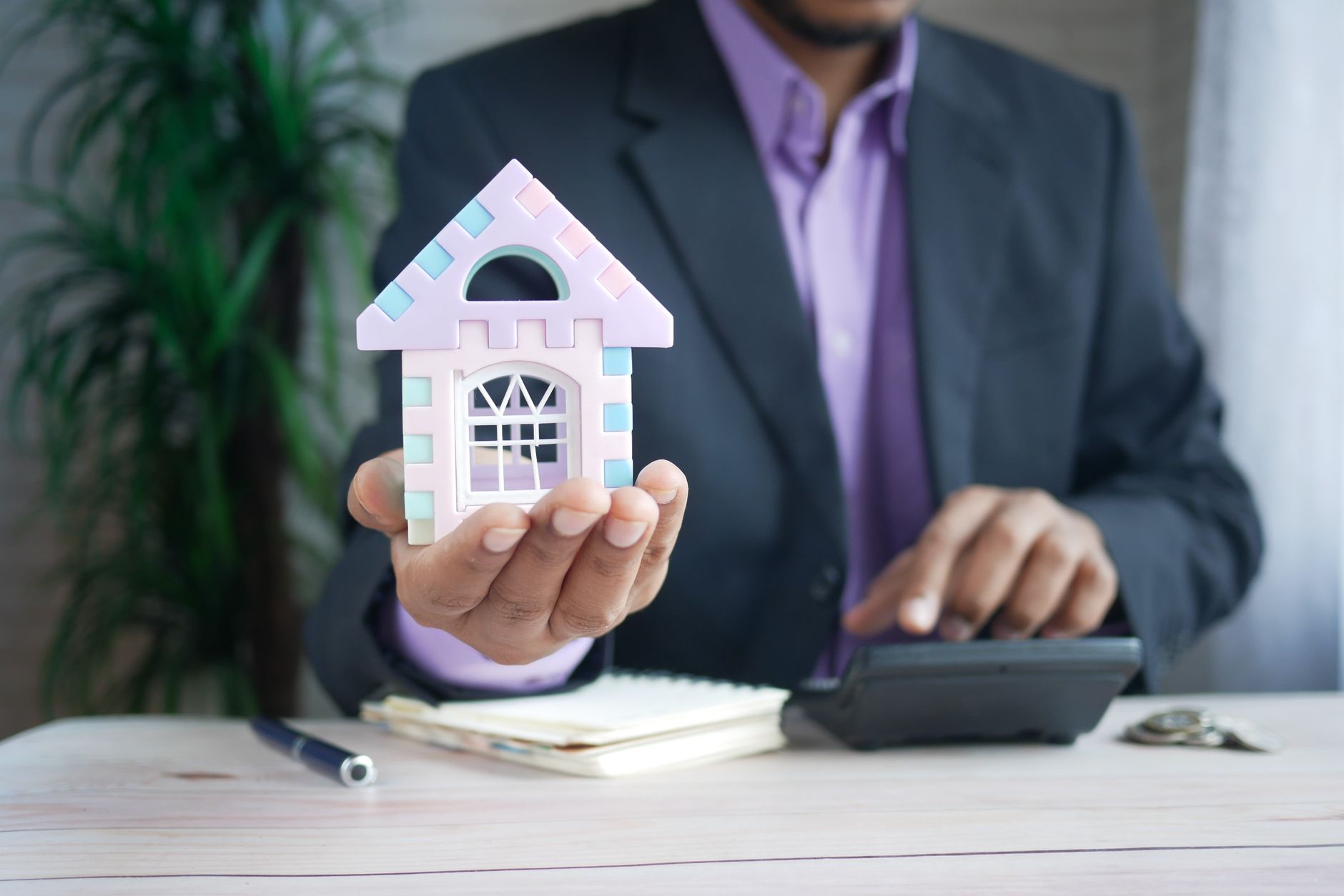 A property appraiser holds a clipboard, assessing a house for fair market valuation.