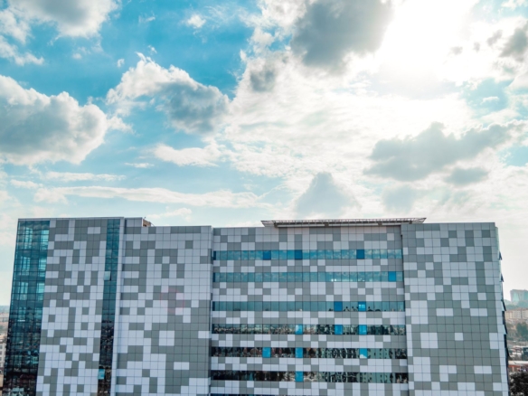 Commercial real estate in Nairobi with modern office towers and apartment blocks, sunny daytime view.
