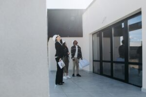 Home appraisal in Kenya: appraiser inspecting a house.